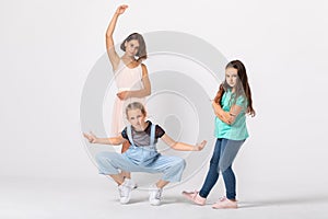 Cool girls fooling around in white room, making funny poses