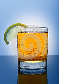 Cool glass of apple juice on a blue background