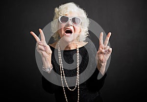 Cool grandmother showing peace sign photo