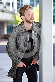 Cool guy with beard smiling outside