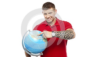 Cool guy holding and pointing at the globe