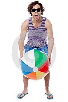 Cool guy playing with beach ball