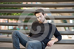Cool guy sitting on steps outdoors