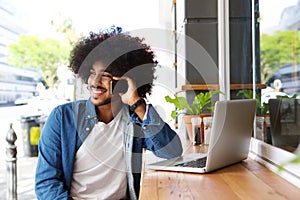 Cool guy using mobile phone and laptop