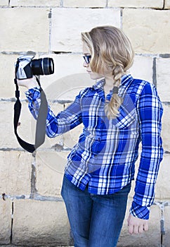 Cool kid holding a camera taking a photo of herself