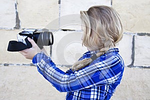 Cool kid holding a camera taking a photo of herself