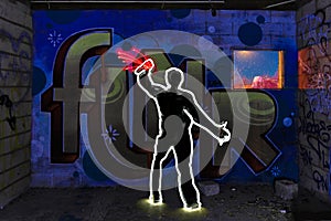 Light Painted Image of Man Tagging with Spray Paint photo