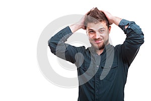 Cool looking young man puts his hands on the head