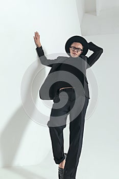 Cool man with hat holding arms in fashion pose and posing