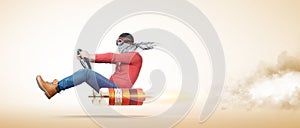 Cool man in stylish goggles and a scarf on his face, drives a car on a rocket engine, on yellow background.