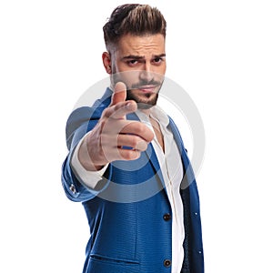 Cool man in suit pointing his finger to camera