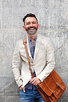 Cool mature man standing against wall