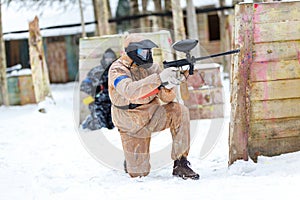 Cool paintball in winter. Two shooters behind fortifications.