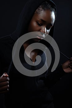 Cool and pensive woman with dark skin and attitude wearing hoodie