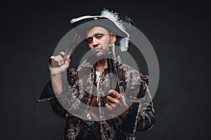 Cool pirate with handguns against dark background