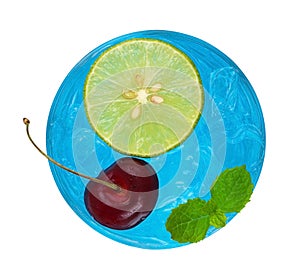 Cool refreshing blue cocktail with cherry and sliced lemon top v