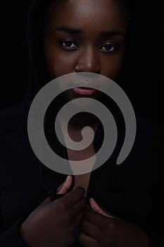 Cool and reticent woman with dark skin and attitude wearing hoodie