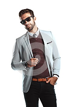Cool style for the fashion conscious guy. Studio shot of a handsome young man posing against a white background.