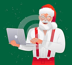 Cool stylish Santa Claus is standing with a laptop in his hands. Santa in a white shirt with suspenders is working at a personal