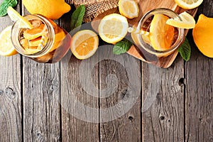 Cool summer iced tea above view top border on a rustic dark wood background