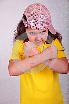 Cool teen age girl with a cap posing and gesturing