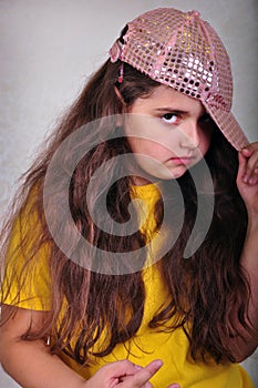 Cool teen age girl with a cap posing and gesturing