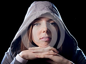 Cool teenager girl or young woman on her 20s posing cool showing attitude wearing hood on