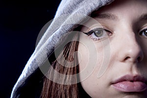 Cool teenager girl or young woman on her 20s posing cool showing attitude wearing hood on