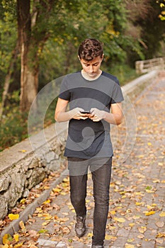Cool teenager with a mobile on the street