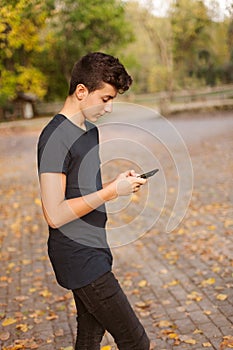 Cool teenager with a mobile on the street