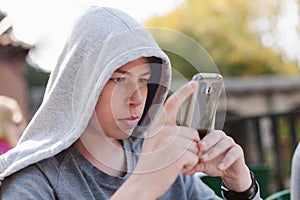 Cool teenager with a mobile on the street