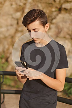 Cool teenager with a mobile on the street