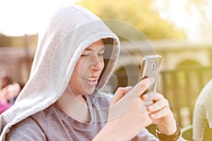 Cool teenager with a mobile on the street