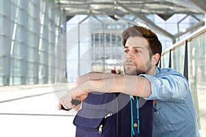 Cool traveler waiting at airport with bag