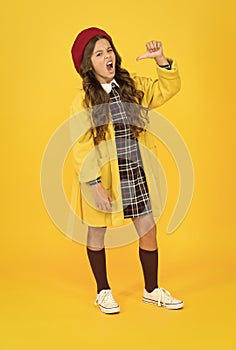cool and trendy. school and fashion. child in pupil uniform. kid in french beret on yellow background. stylish teen