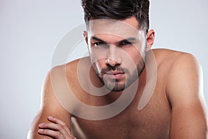 Cool undressed man sitting with hands crossed