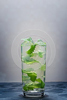 Cool water in a glass of ice and mint petals.Soft drink.