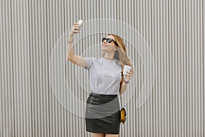 Cool woman with stylish clothes taking a picture to herself