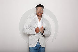 Cool young african american businessman smiling against gray background