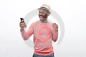 Cool young african american man listening to music with earphones and mobile phone