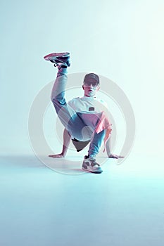 Cool young breakdancer guy dancing hip-hop in neon light. Dance school poster. Battle competition announcement