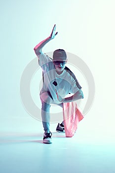 Cool young breakdancer guy in studio in neon light. Dance school poster. Battle competition announcement