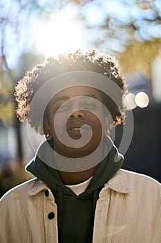 Cool young gen z hipster African American teen in sunny city park. Portrait