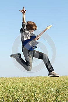 Cool young guitarist jumping