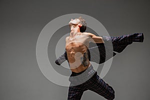 Cool young guy dancer in suit dancing in studio. Dance school poster. Break dance lessons