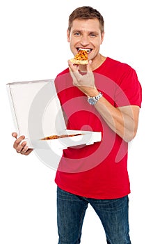 Cool young guy enjoying pizza