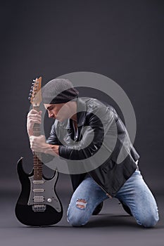 Cool young male guitarist is very frustrated