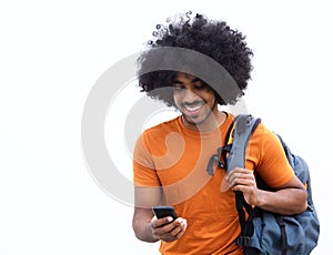 Cool young man with bag looking at mobile phone