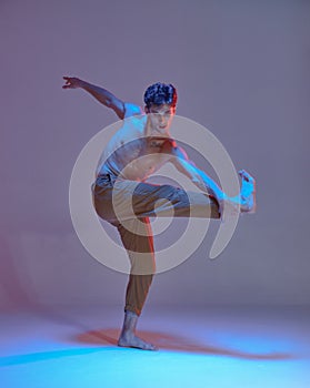 Cool young man breakdancer dancing hip-hop without shirt in neon lilac light. Dance school poster. Break dance lessons