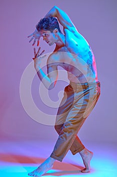 Cool young man dancing expressive dance without shirt in neon light. Colorful dance school poster